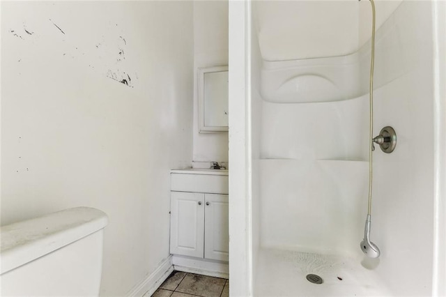 full bath with baseboards, toilet, tile patterned floors, vanity, and a shower