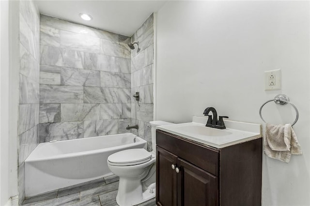 bathroom with bathing tub / shower combination, toilet, wood finished floors, and vanity