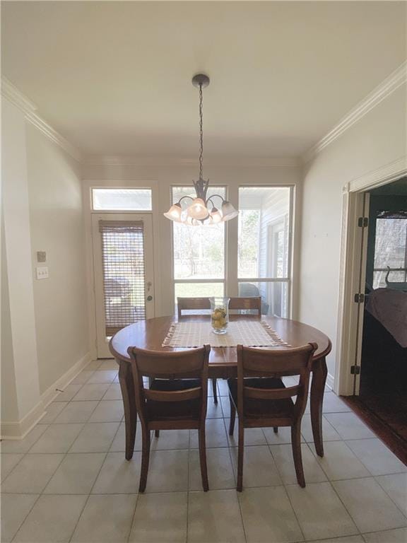 dining space with a wealth of natural light, baseboards, crown molding, and an inviting chandelier