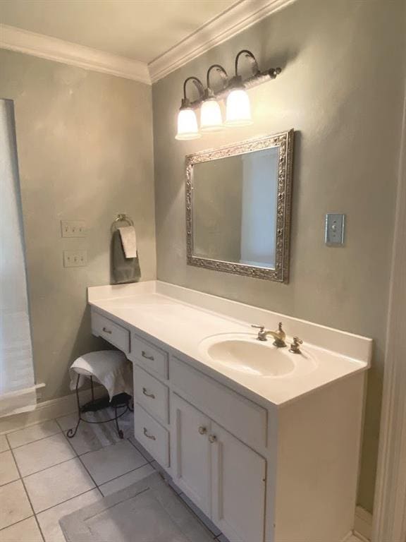 bathroom with tile patterned flooring, vanity, crown molding, and baseboards