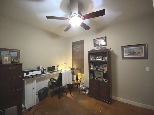 office space featuring baseboards and ceiling fan