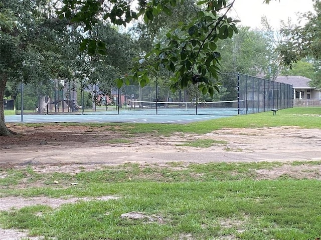 surrounding community with a tennis court and fence