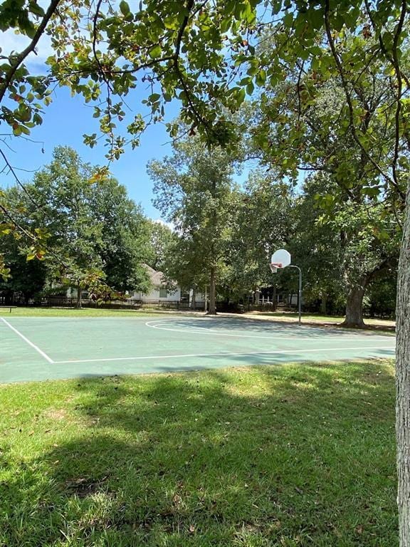 view of basketball court with a lawn and community basketball court