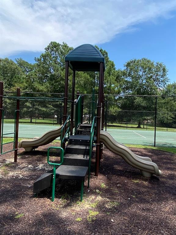 community jungle gym featuring fence