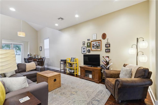 living area featuring visible vents, baseboards, dark wood finished floors, lofted ceiling, and recessed lighting