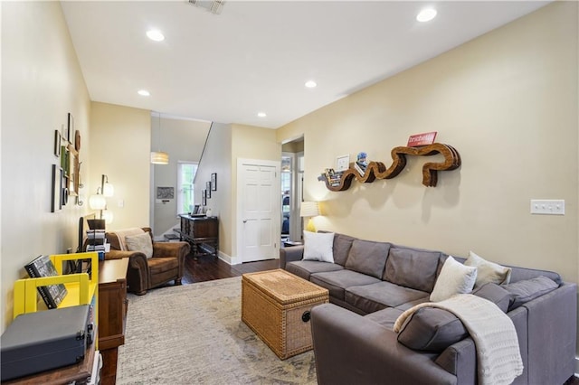 living room with recessed lighting, wood finished floors, visible vents, and baseboards