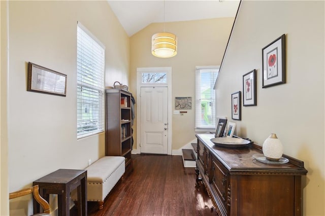 foyer with baseboards, dark wood-style flooring, and vaulted ceiling