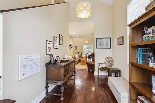 corridor with hardwood / wood-style flooring and baseboards