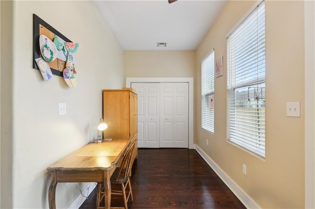 office space featuring dark wood finished floors, visible vents, and baseboards