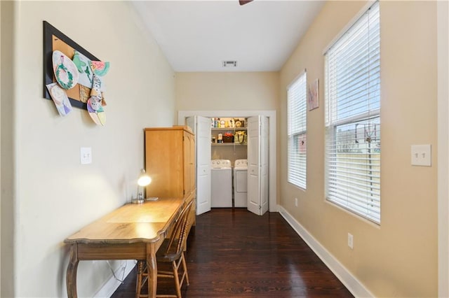 corridor with visible vents, dark wood-style floors, baseboards, and washing machine and clothes dryer