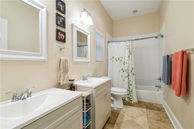 bathroom featuring toilet, two vanities, shower / tub combo, and a sink