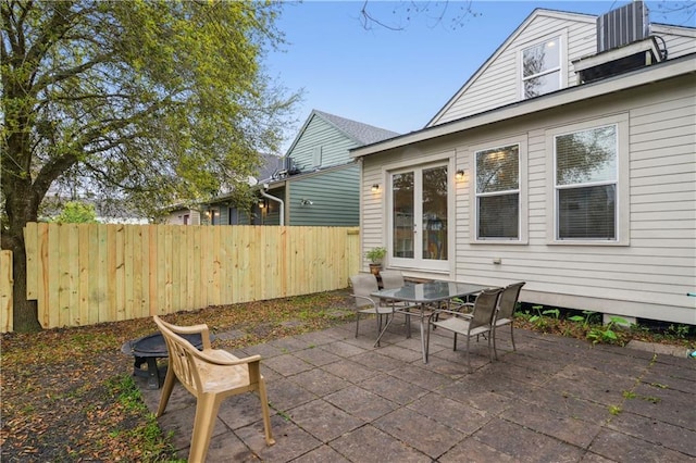 view of patio / terrace with central AC unit and fence