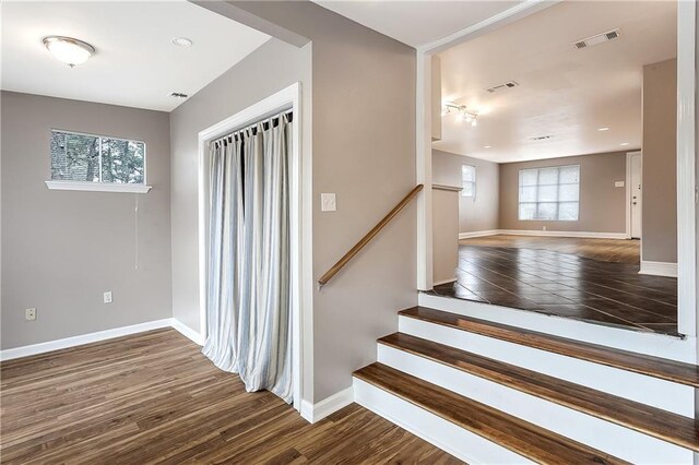 20087 Quincy Ave, Covington, LA 70433 - stairs featuring wood finished floors, a healthy amount of sunlight, visible vents, and baseboards