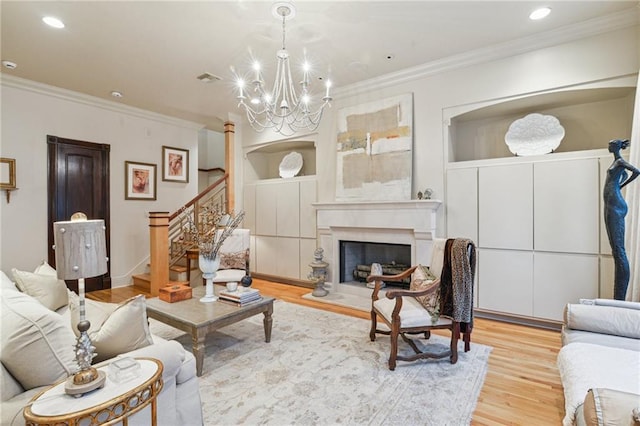 living area featuring stairs, crown molding, a notable chandelier, and wood finished floors