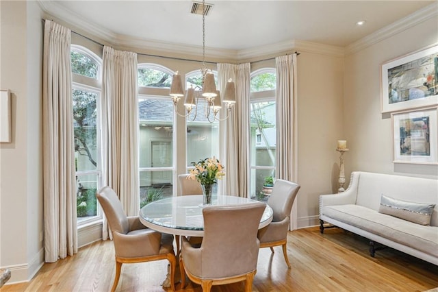 dining room with visible vents, a notable chandelier, a healthy amount of sunlight, and crown molding