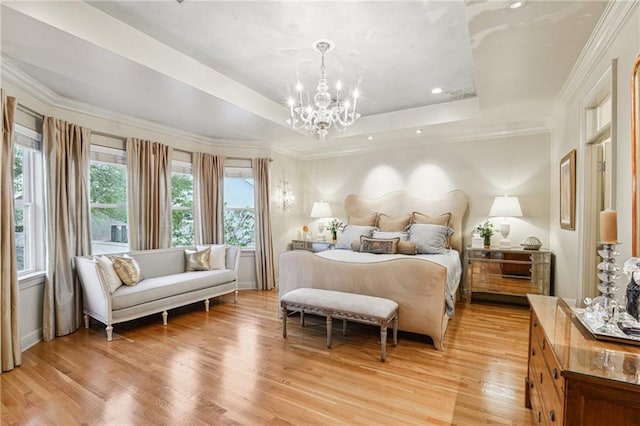 bedroom featuring an inviting chandelier, a tray ceiling, recessed lighting, ornamental molding, and light wood-style floors