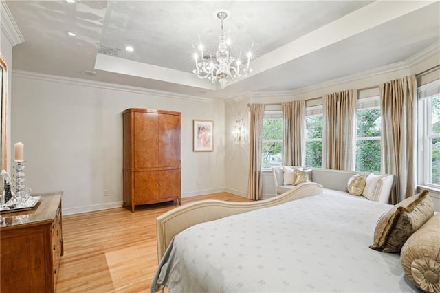 bedroom featuring crown molding, baseboards, light wood-type flooring, an inviting chandelier, and a raised ceiling