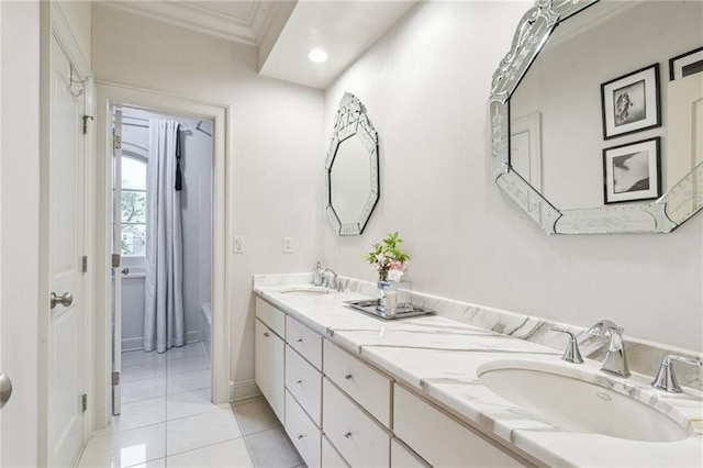 full bathroom with tile patterned flooring, ornamental molding, double vanity, and a sink