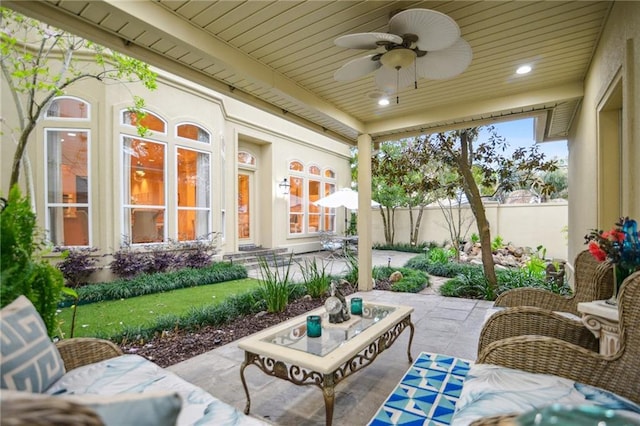 view of patio with ceiling fan and fence