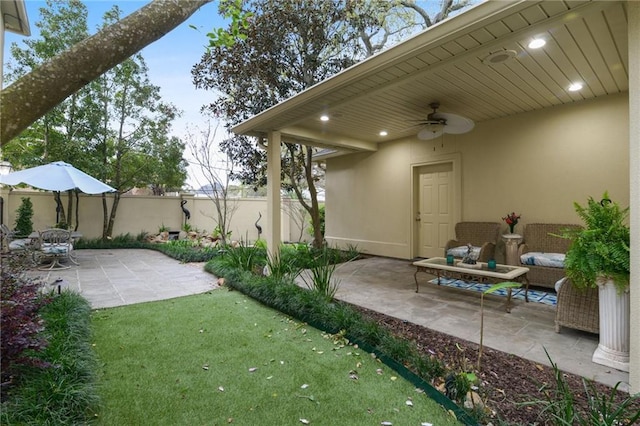 view of yard featuring ceiling fan, a patio, and fence