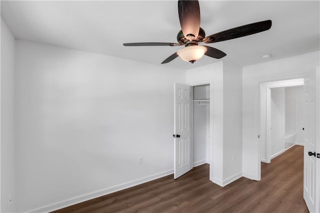 365 Olive Dr, Slidell, LA 70458 - unfurnished bedroom featuring dark wood-style floors, a closet, baseboards, and a ceiling fan