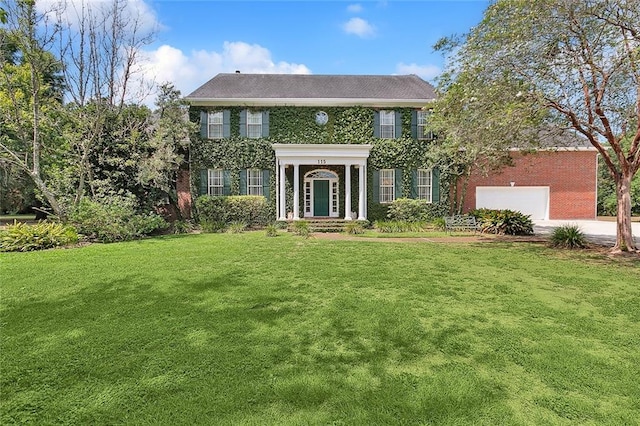 115 Cambridge Dr, Belle Chasse, LA 70037 - colonial house featuring a front lawn, an attached garage, and concrete driveway