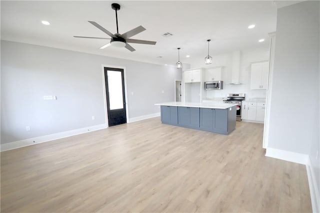 134 Gourgues St, Hahnville, LA 70057 - kitchen with stainless steel appliances, ceiling fan, baseboards, white cabinets, and open floor plan