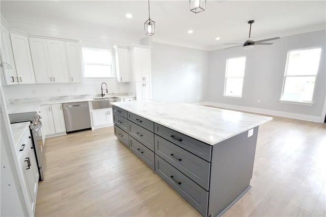 134 Gourgues St, Hahnville, LA 70057 - kitchen with white cabinets, a sink, stainless steel appliances, plenty of natural light, and gray cabinets