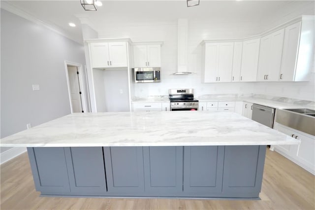 134 Gourgues St, Hahnville, LA 70057 - kitchen with appliances with stainless steel finishes, ornamental molding, a large island, and white cabinets