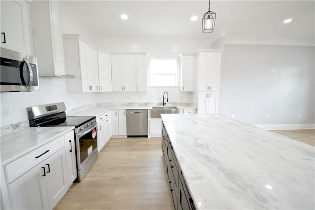 134 Gourgues St, Hahnville, LA 70057 - kitchen featuring appliances with stainless steel finishes, white cabinetry, light wood-type flooring, and a sink