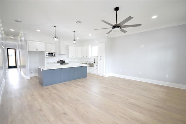 134 Gourgues St, Hahnville, LA 70057 - kitchen with white cabinetry, stainless steel appliances, visible vents, and baseboards