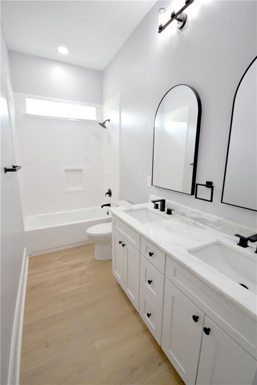 134 Gourgues St, Hahnville, LA 70057 - bathroom featuring double vanity, a sink, shower / tub combination, and wood finished floors