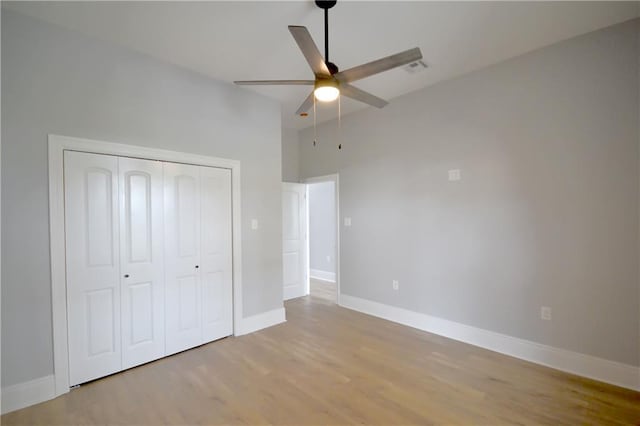 134 Gourgues St, Hahnville, LA 70057 - unfurnished bedroom featuring light wood finished floors, a closet, a ceiling fan, and baseboards