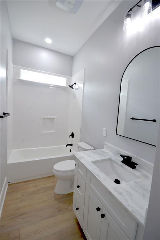 134 Gourgues St, Hahnville, LA 70057 - full bathroom featuring shower / bathing tub combination, wood finished floors, vanity, and toilet
