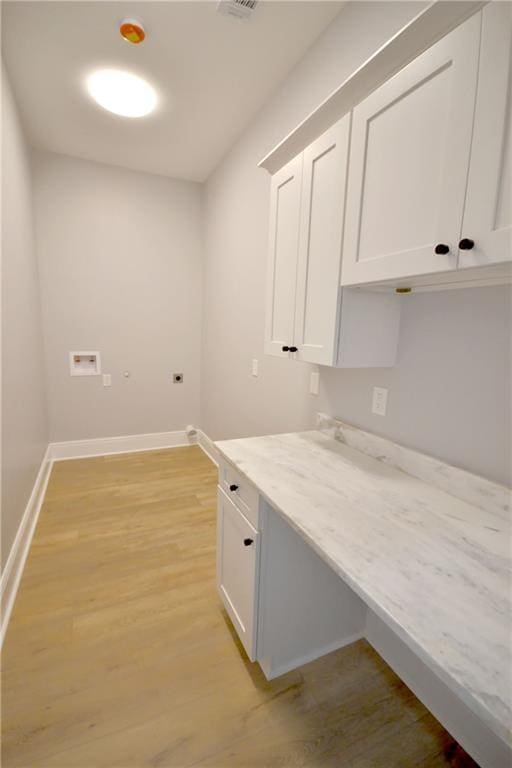 134 Gourgues St, Hahnville, LA 70057 - interior space featuring cabinet space, washer hookup, light wood finished floors, and baseboards