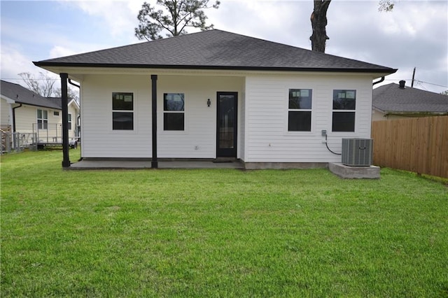 134 Gourgues St, Hahnville, LA 70057 - back of house featuring cooling unit, a yard, a shingled roof, and a fenced backyard