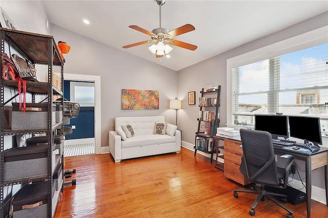 home office featuring ceiling fan, light wood-style flooring, recessed lighting, lofted ceiling, and baseboards