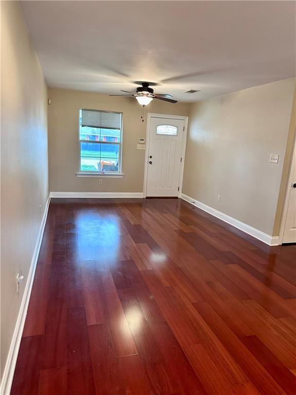 foyer featuring visible vents, baseboards, wood finished floors, and a ceiling fan