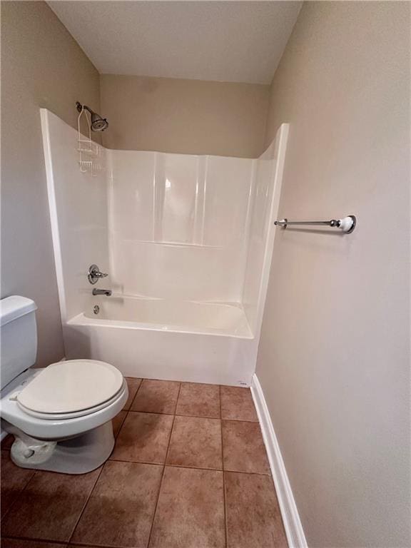bathroom with tile patterned floors, shower / bath combination, baseboards, and toilet