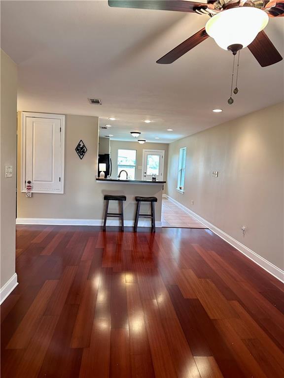 interior space with visible vents, baseboards, and hardwood / wood-style floors