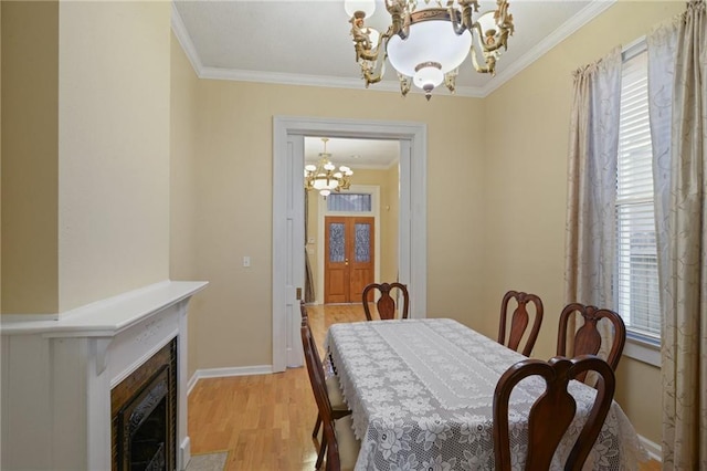 dining space featuring an inviting chandelier, plenty of natural light, and ornamental molding