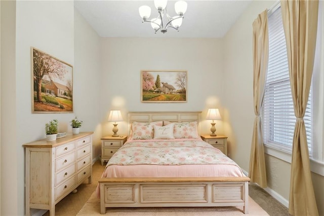 bedroom featuring light colored carpet and a chandelier