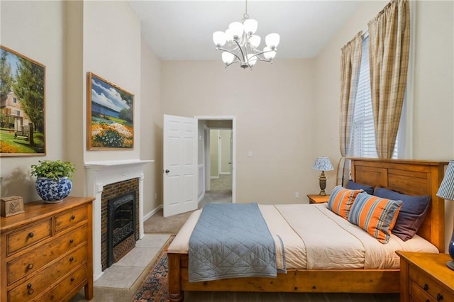 bedroom featuring light carpet, a chandelier, and a fireplace