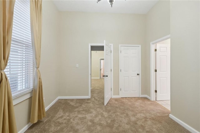 unfurnished bedroom with carpet and baseboards