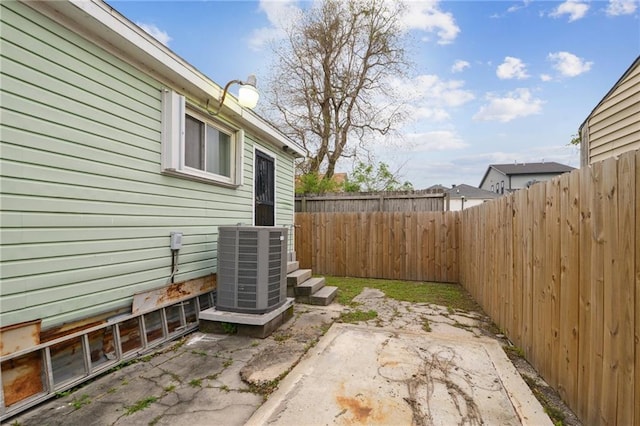 exterior space with a patio, a fenced backyard, and central AC unit