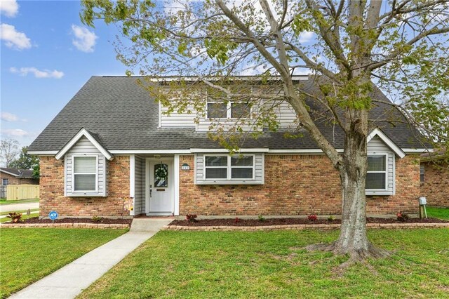 448 Lynnmeade Rd, Gretna, LA 70056 - view of front of home featuring brick siding, a front yard, and roof with shingles