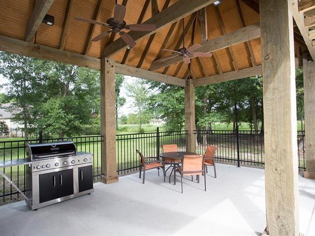 view of patio / terrace featuring outdoor dining space, a ceiling fan, fence, a gazebo, and a grill