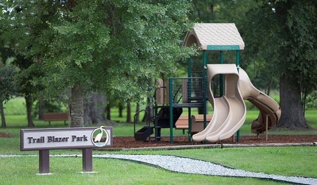 community jungle gym featuring a lawn