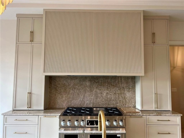 138 Wood Duck Dr, Belle Chasse, LA 70037 - kitchen featuring high end stove, extractor fan, tasteful backsplash, light stone countertops, and cream cabinetry