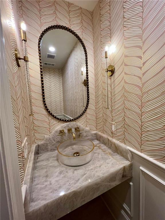 138 Wood Duck Dr, Belle Chasse, LA 70037 - bathroom featuring wallpapered walls and a sink